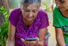 Duas senhoras de idade mexendo no celular.